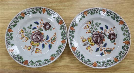 A pair of Delft tin-glazed earthenware plates, painted in polychrome enamels, c.1780, diameter 23cm (a.f.)